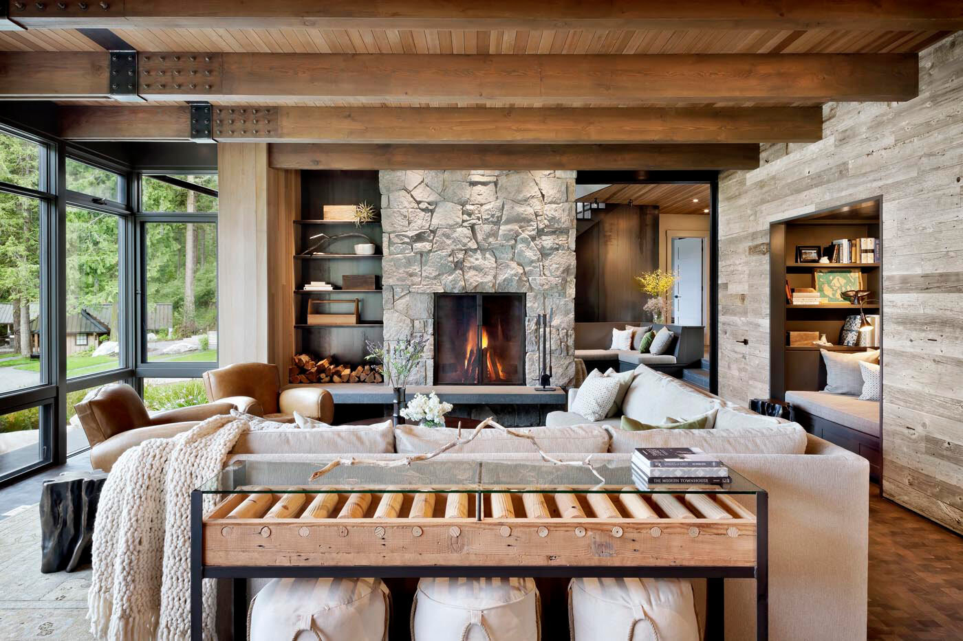 rustic ocean home large living room with stone fireplace and large windows