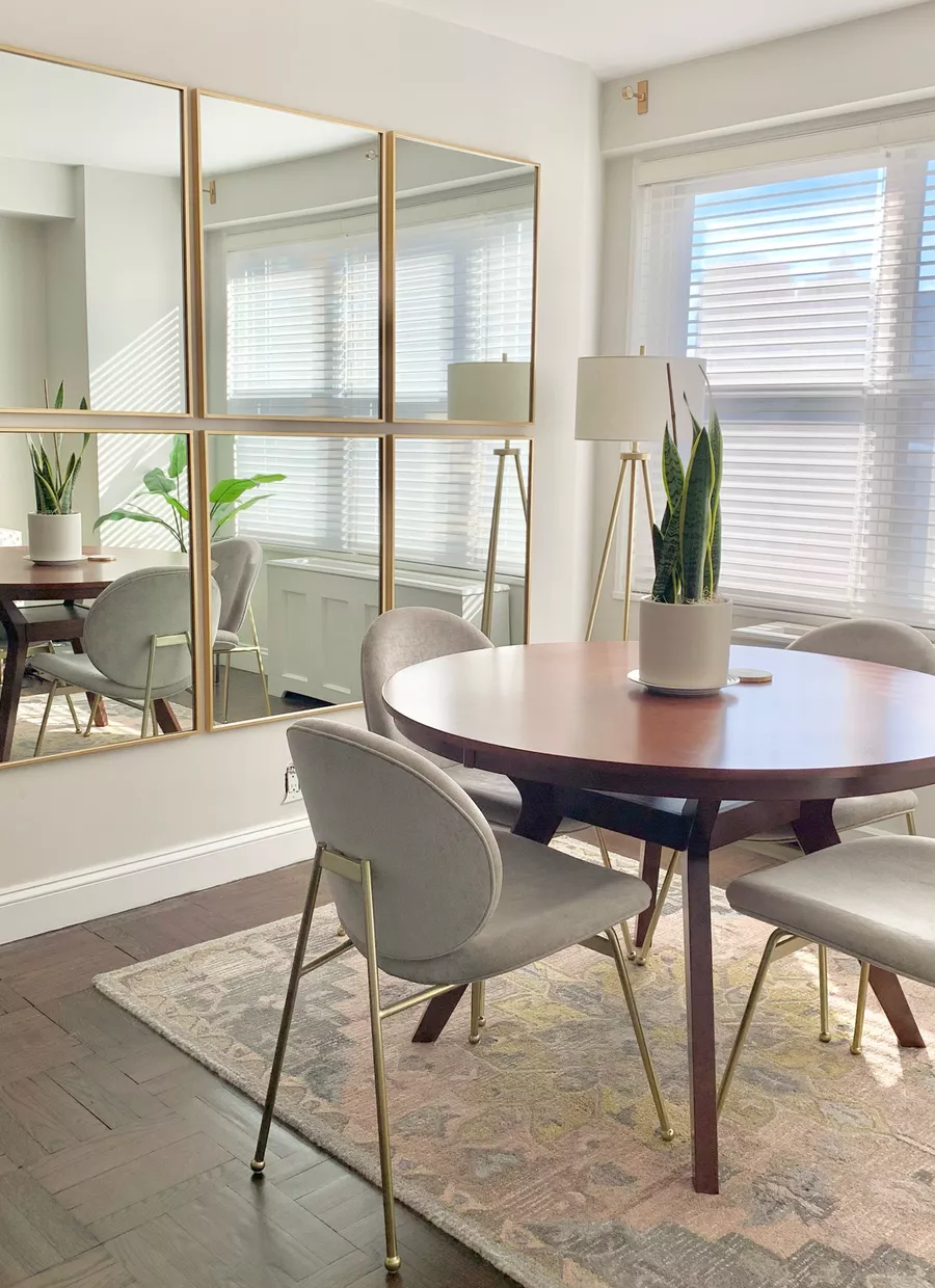 dining room with round table and Mirror gallery wall